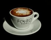 Close-up of a cappuccino with intricate latte art in a Rome café. Ideal stock photo for coffee enthusiasts.