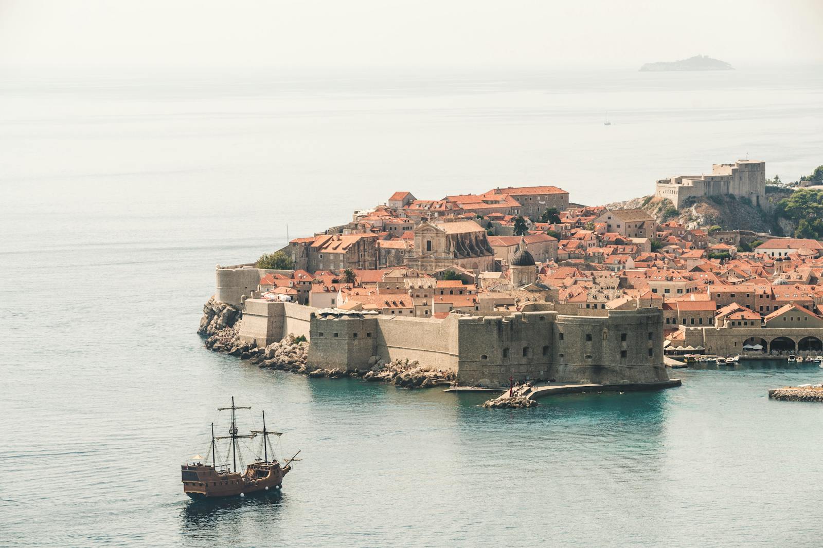 Stunning aerial photo of Dubrovnik's old town and city walls by the Adriatic Sea.