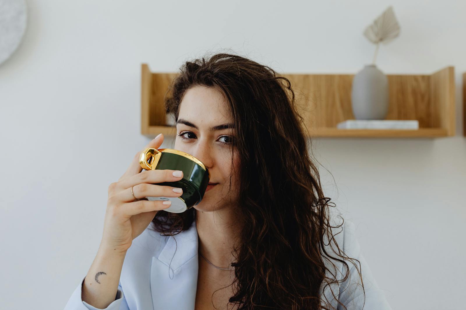 Close-up of a woman savoring a beverage, creating a cozy atmosphere.