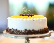 Elegant cake with fruits and chocolate shavings, perfect for celebrations.