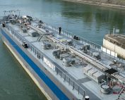 Aerial view of an industrial oil tanker docked at a harbor, showcasing modern maritime technology.