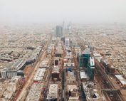 Aerial photograph of Riyadh's modern cityscape with iconic skyscrapers and bustling streets.