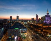 Beautiful Warsaw skyline at twilight showcasing modern architecture and vibrant city lights.