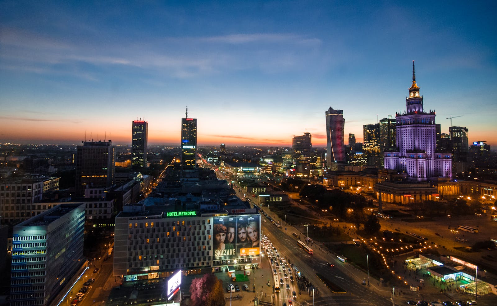 Beautiful Warsaw skyline at twilight showcasing modern architecture and vibrant city lights.