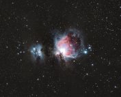 A breathtaking photograph of the Orion Nebula amidst a starry night sky, capturing celestial beauty.