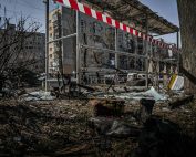 A demolished bus stop in Kyiv, Ukraine, showcasing signs of conflict and devastation.