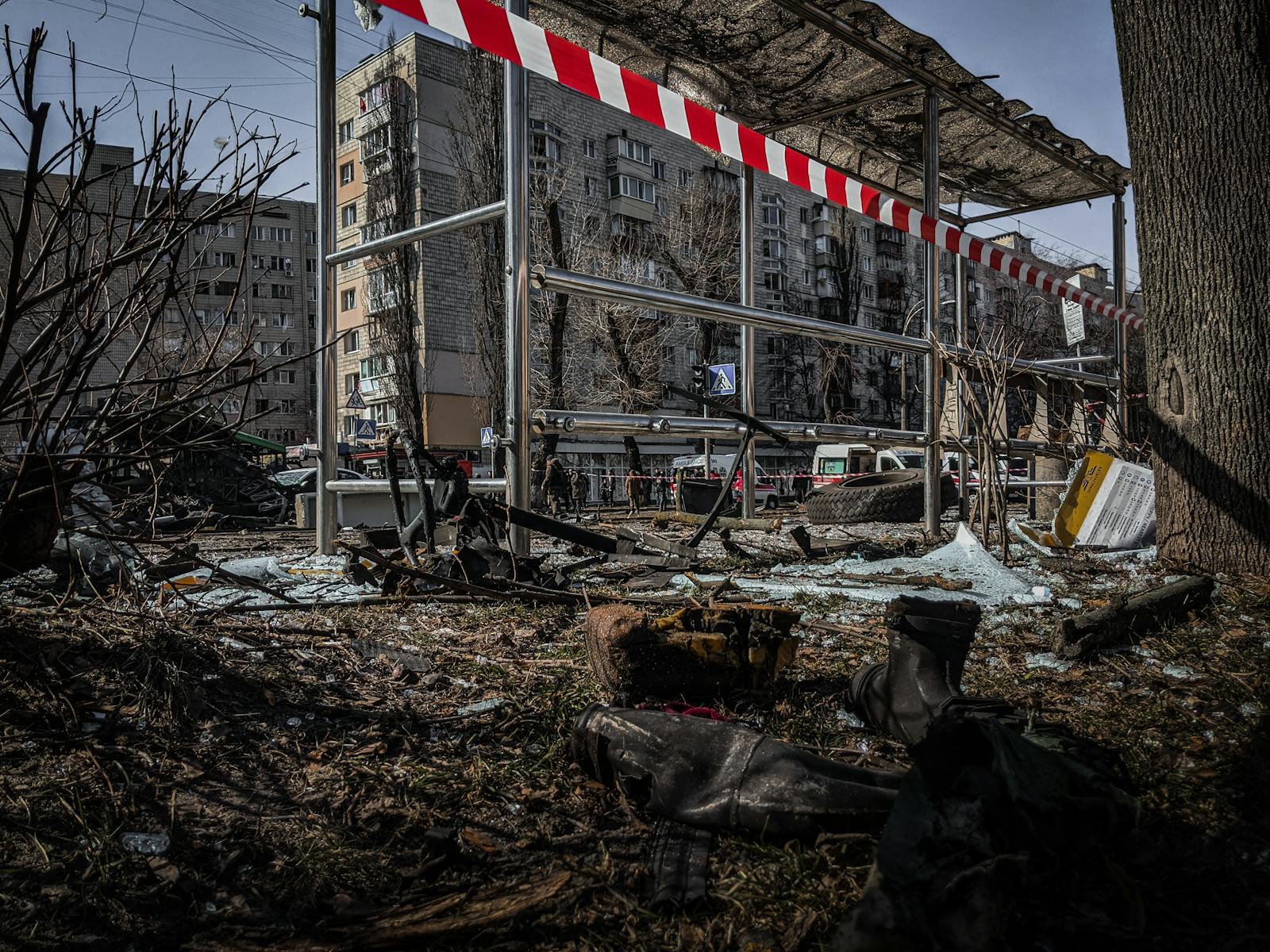 A demolished bus stop in Kyiv, Ukraine, showcasing signs of conflict and devastation.