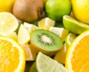 Close-up of fresh sliced citrus fruits and kiwi, showcasing vibrant colors and juicy textures.