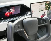 Premium Tesla dashboard featuring dual screens and innovative steering wheel design.