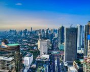 A breathtaking aerial view of Jakarta's urban skyline during the day, showcasing skyscrapers and city life.