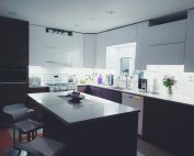 Contemporary kitchen interior with sleek white cabinets and island, perfect for a minimalist aesthetic.