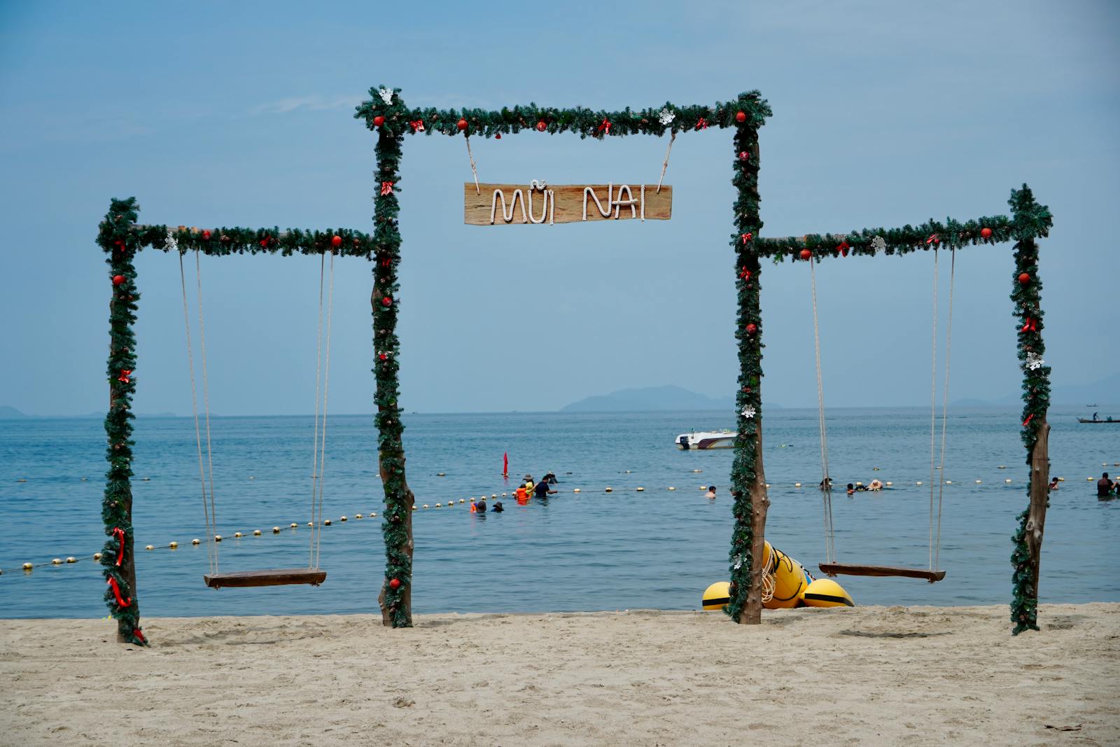 Decorated beach swings overlooking the ocean at Mui Nai, Vietnam, a perfect tropical getaway.