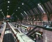 Dynamic view of a busy train station in England with commuters on the move.
