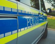 Close-up of a German police car labeled 'Polizei' parked outdoors on a sunny day.