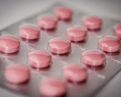 Pink tablets in a blister pack, emphasizing healthcare and medication concepts.