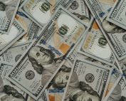 Close-up of American 100 dollar bills scattered, highlighting wealth and currency concepts.