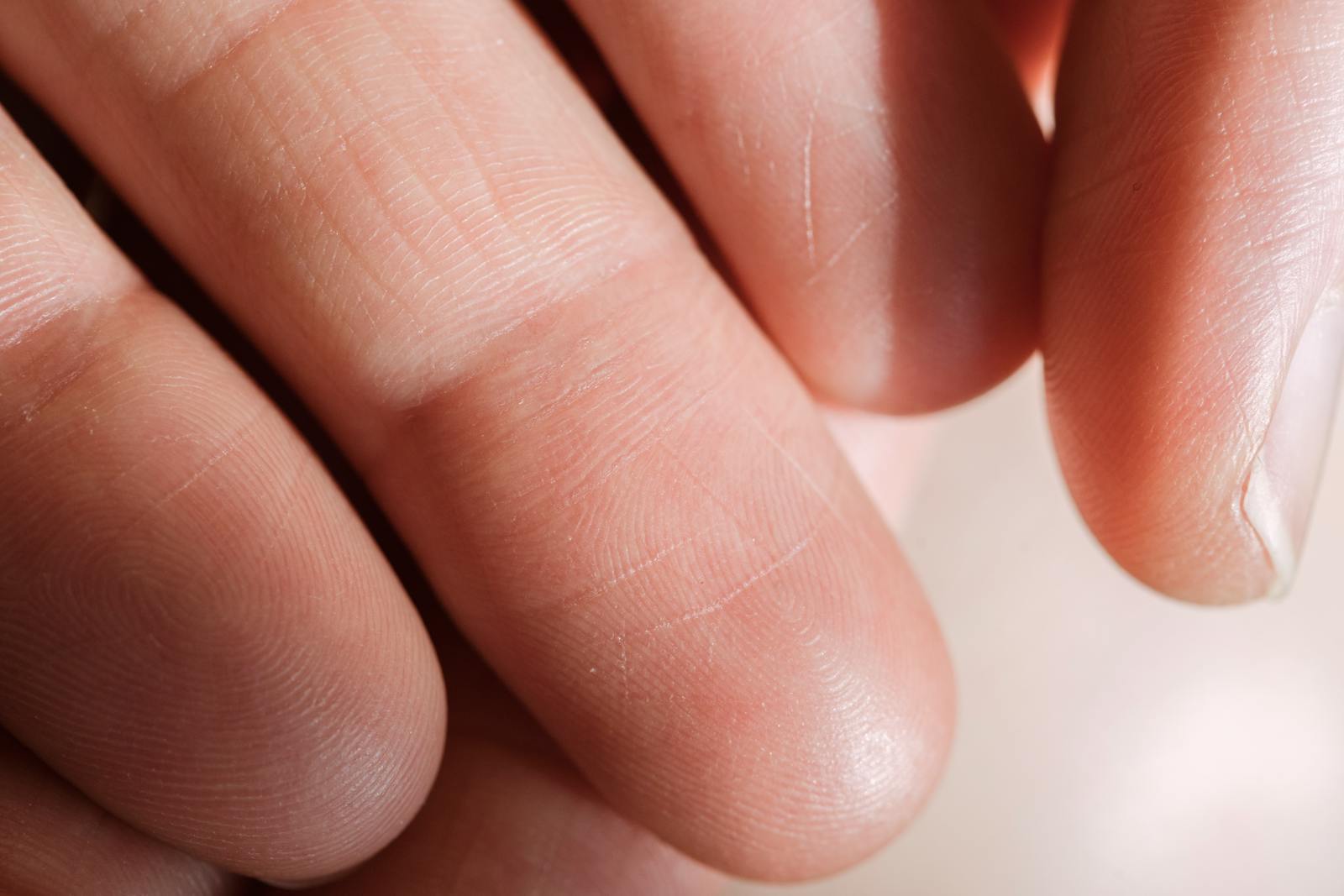 Detailed close-up of human fingers showing skin texture and fingerprints.