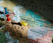 Colorful pushpins marking locations on a detailed map of Central Asia.