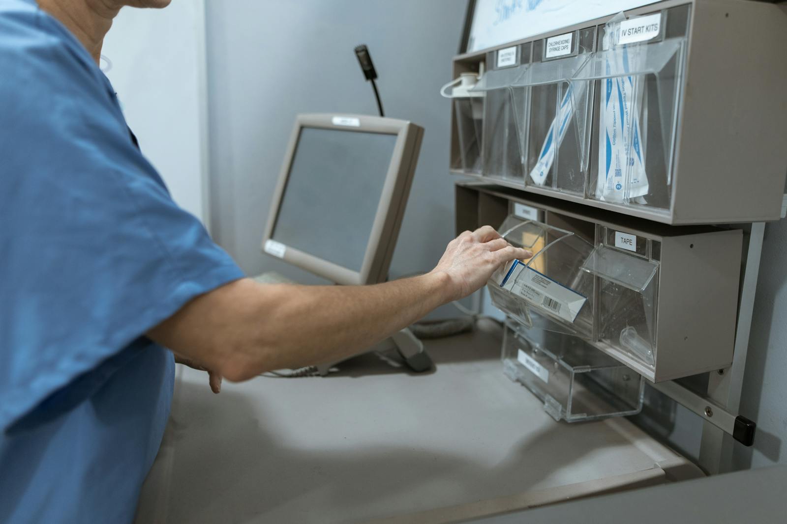 A medical professional organizing supplies in a hospital setting.