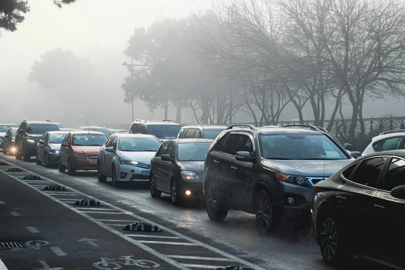 Cars are in a traffic jam on a foggy day.