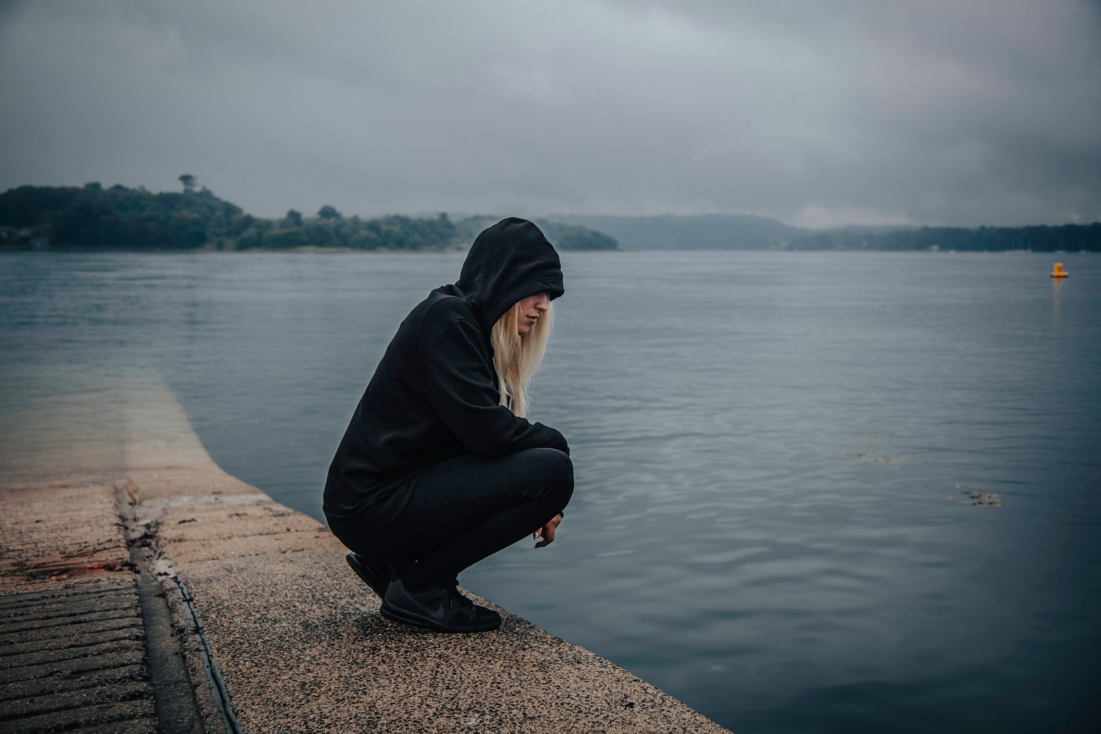 woman almost sitting near seashore