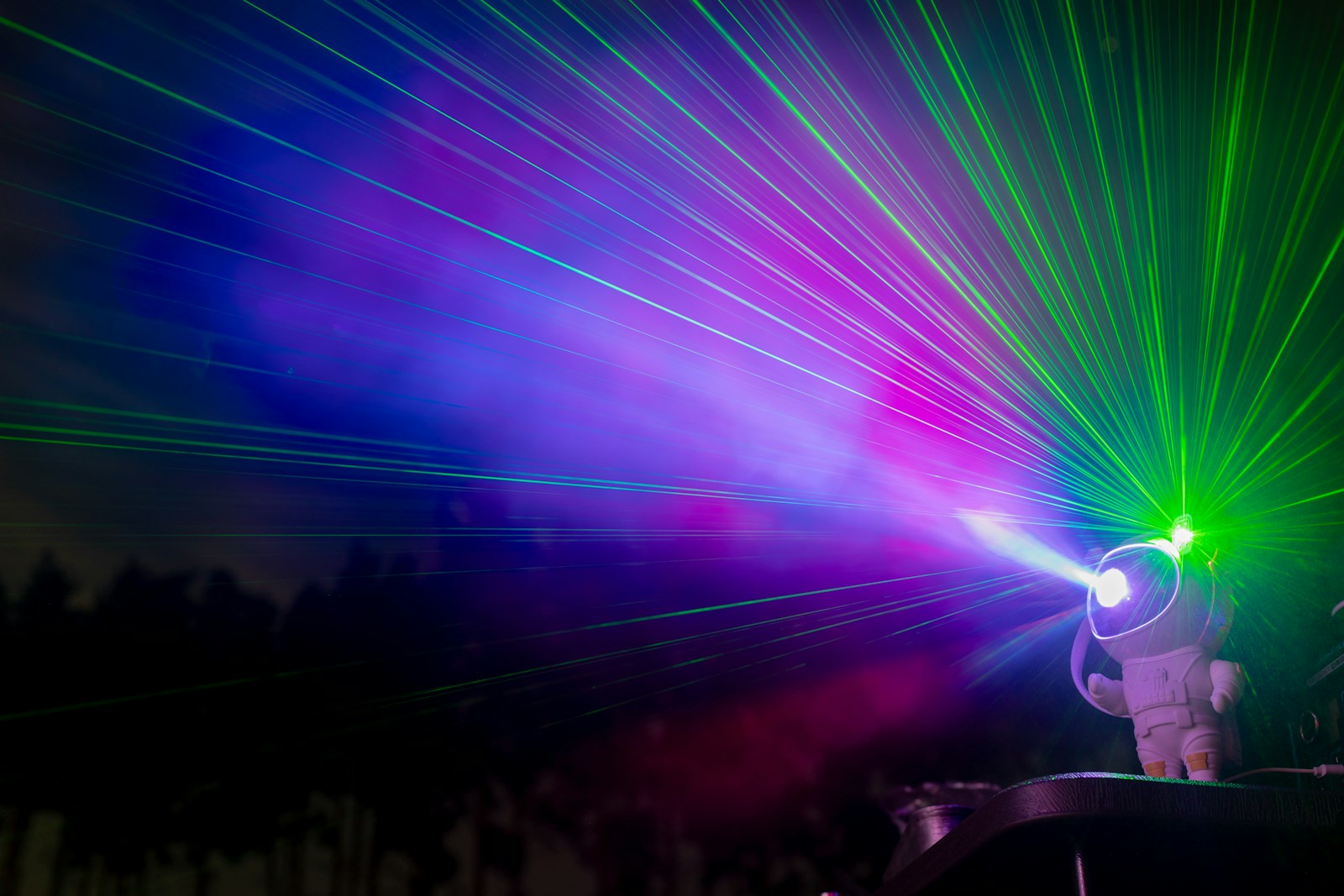 A person holding a light up in the dark