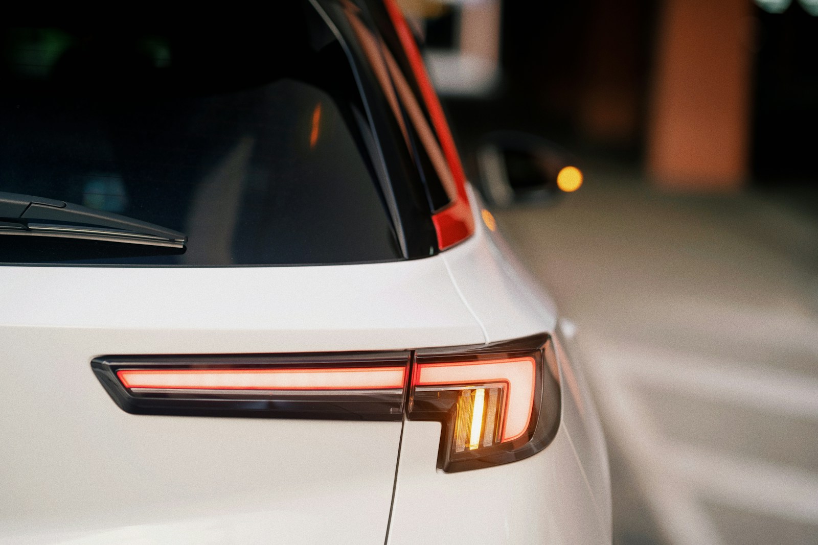 a close up of the tail lights of a white car