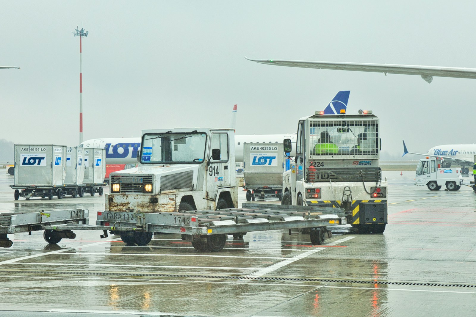 a group of trucks parked on top of an airport tarmac