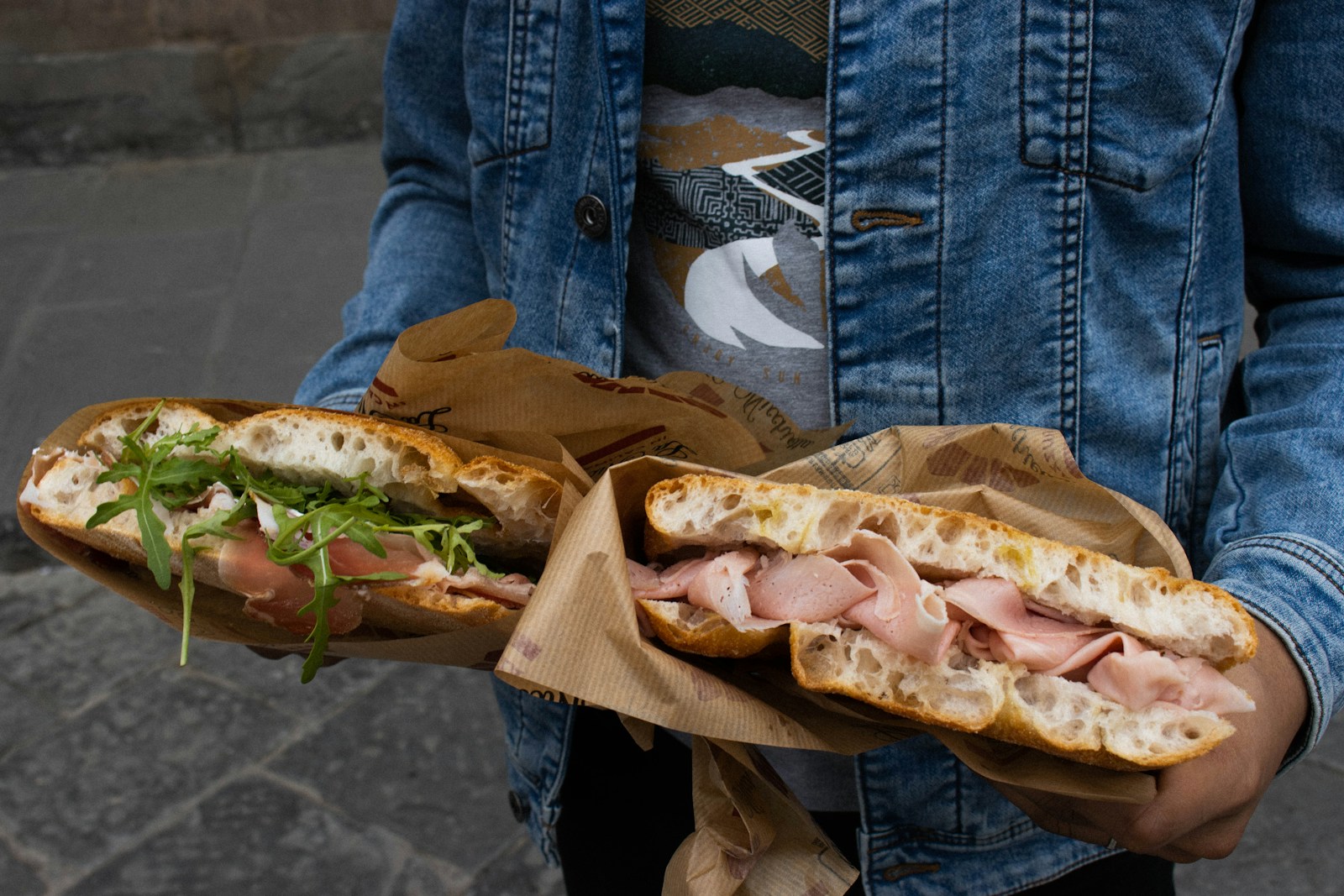 a person holding a sandwich in their hands