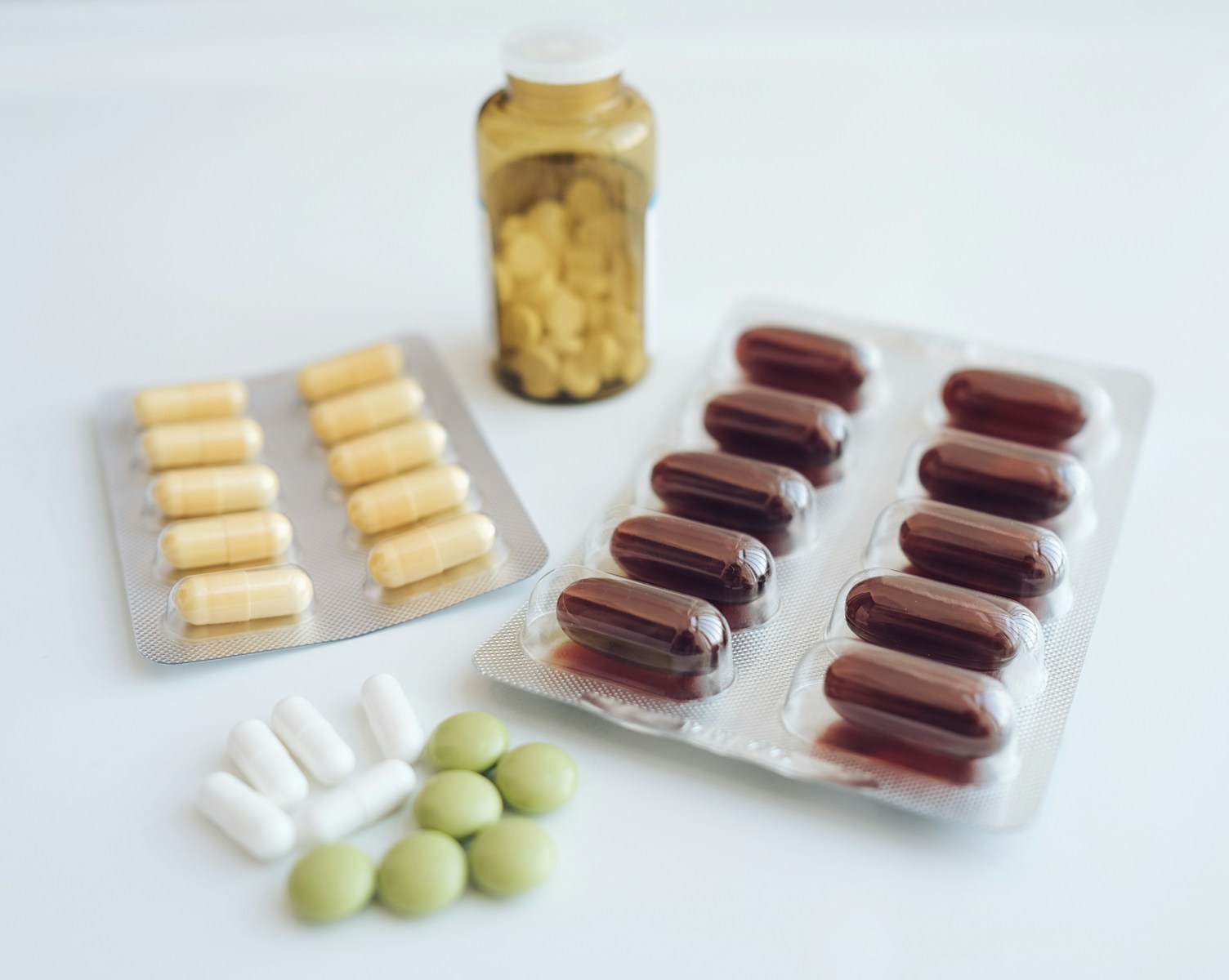 a table topped with pills and a bottle of pills