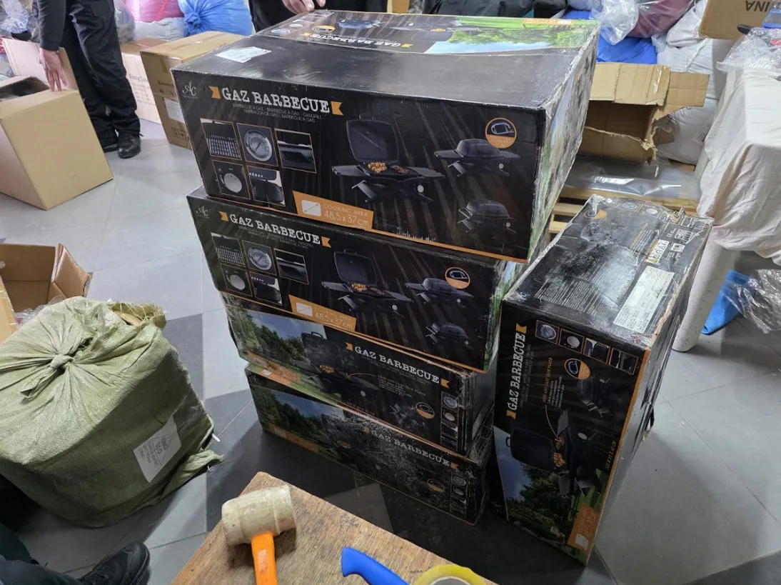 Pet složenih kutija roštilja na gas (Gaz Barbeque) na paleti, spremljenih u skladištu.