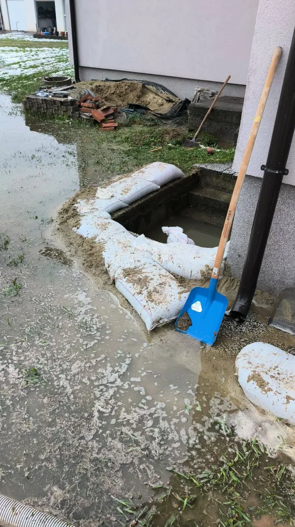 Pijesak i vreće postavljene kao prepreka za prodor vode u dvorištu pored kuće.