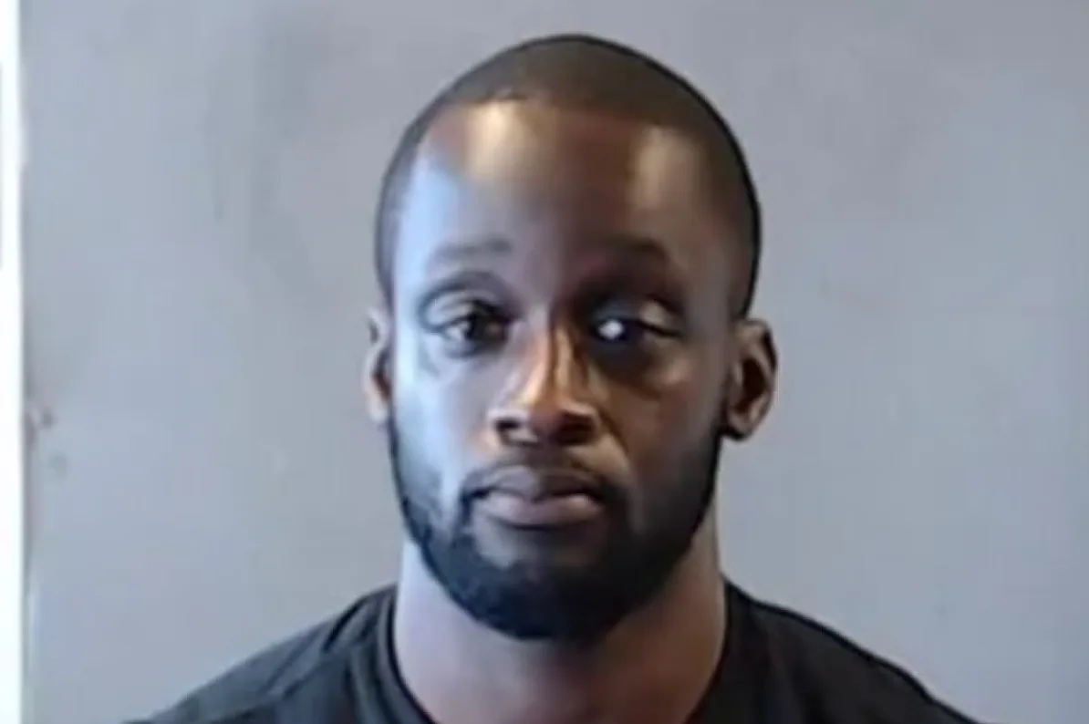 Crnac muškarac sa kratkom kosom i bradom, gleda u kameru.