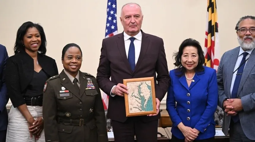 Grupa diplomata i vojnih zvaničnika pozira sa poklonom u obliku mape Zaliva Česapeke.