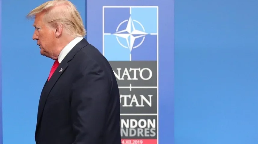 Donald Trump is seen in profile in front of a NATO banner during a summit in London in December 2019.