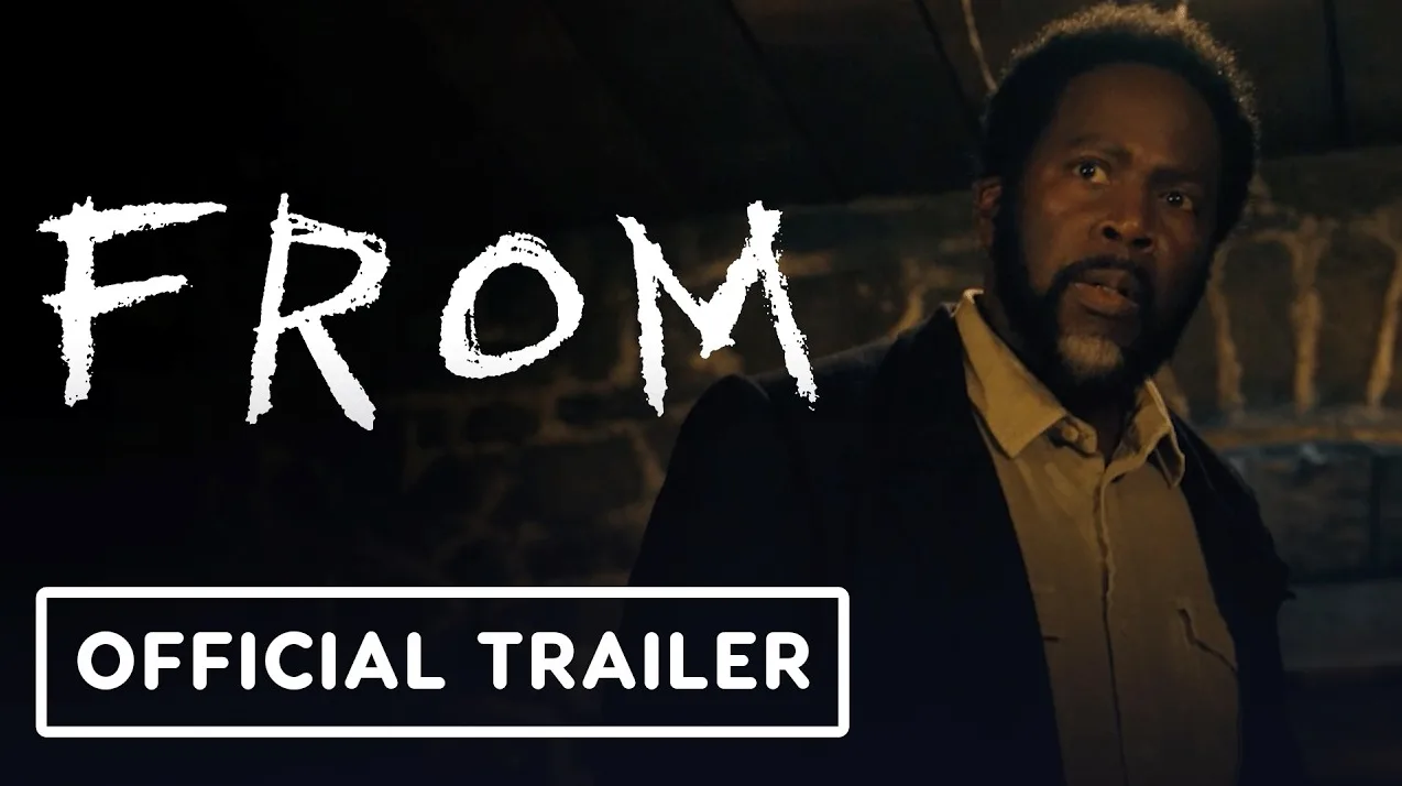 Čovjek sa crnom kosom i bradom, noseći tamni kaput preko košulje, gleda iznenađeno na lijevu stranu, dok se na lijevoj strani slike vide bijela slova "FROM". Ispod se nalazi natpis "OFFICIAL TRAILER" u bijelom okviru.