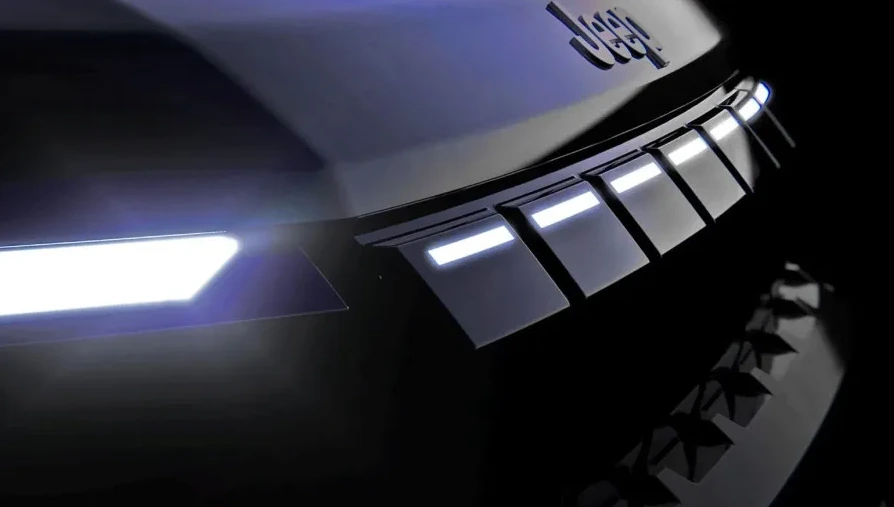 Detalj prednjeg dijela futurističkog Jeep koncept vozila sa istaknutim LED svjetlima i stilizovanom rešetkom hladnjaka.