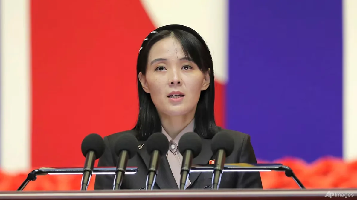 Kim Yo Jong govori pred brojnim mikrofonima.