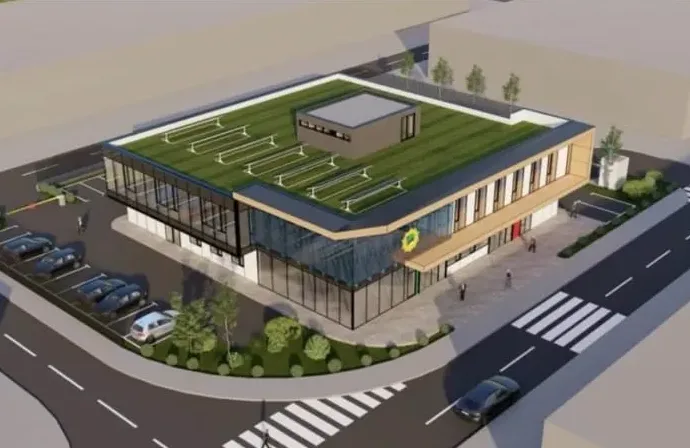 Render savremene poslovne zgrade sa zelenim krovom, solarnim panelima, velikim staklenim površinama i parkingom.