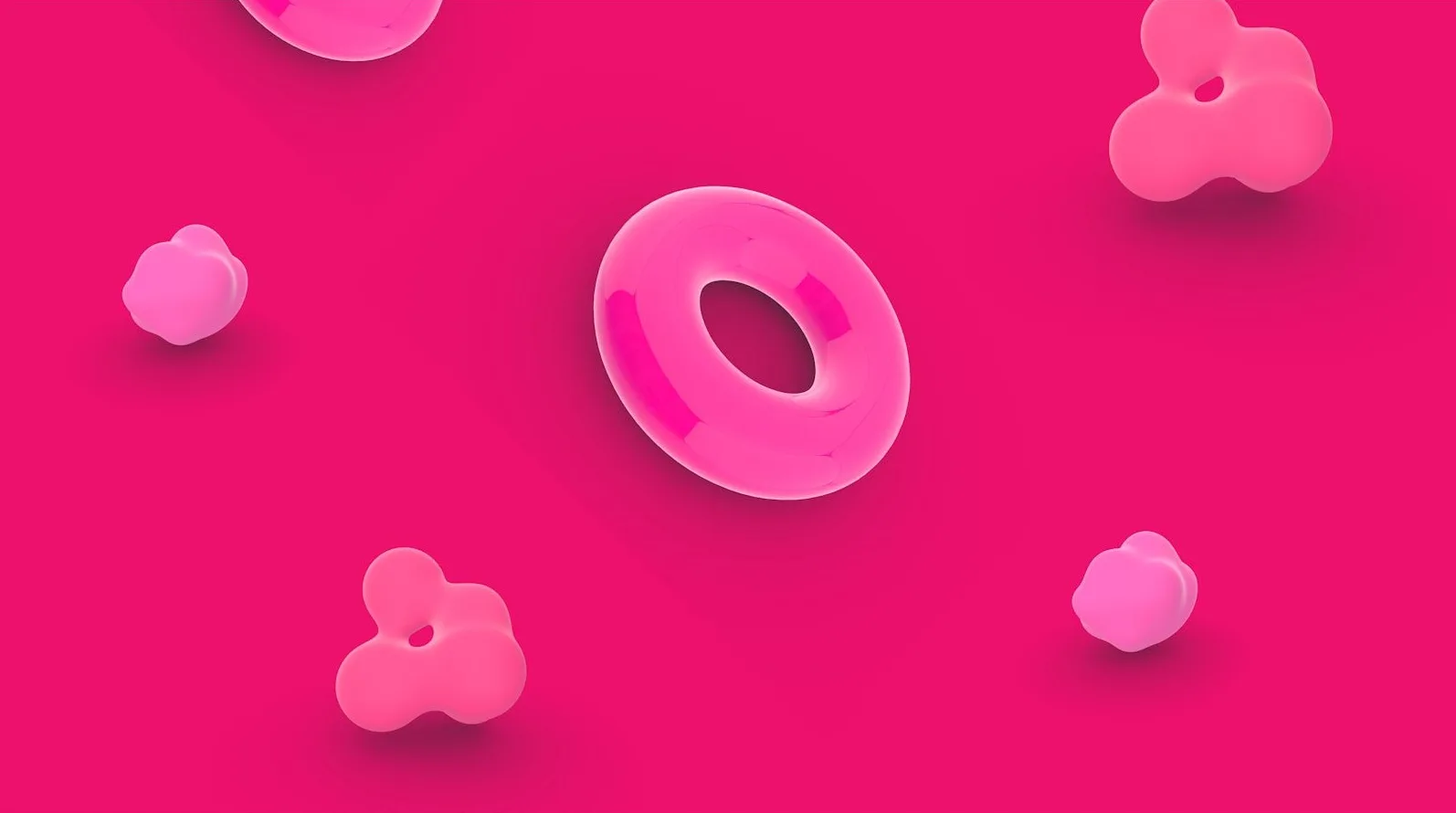 Apstraktni roze oblici, uključujući torus i amorfne oblike, lebde na jarko roze pozadini.