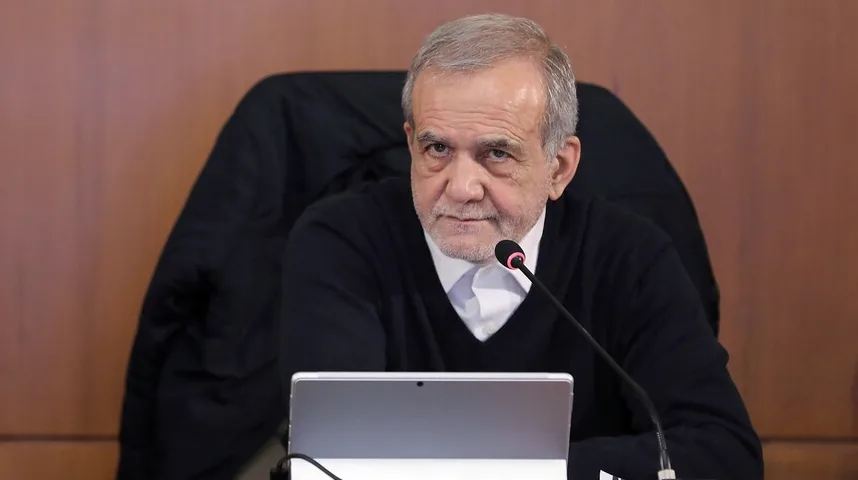 Portret starijeg gospodina sa sijedom kosom, koji sjedi za stolom ispred mikrofona i laptopa, gleda prema naprijed.