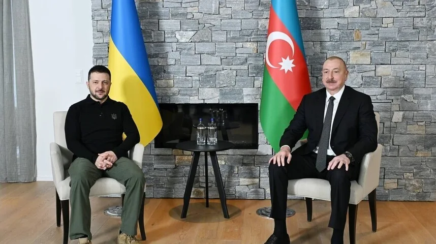 Volodimir Zelenski i Ilham Alijev sjede jedan pored drugog ispred zastava Ukrajine i Azerbejdžana.