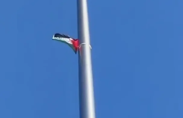 Dio zastave Palestine sa zelenom, bijelom, crnom i crvenom bojom, pričvršćen za srebrni jarbol.