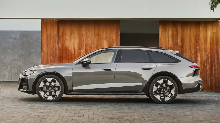Sivi Audi A6 Allroad Quattro parkiran ispred moderne drvene fasade.