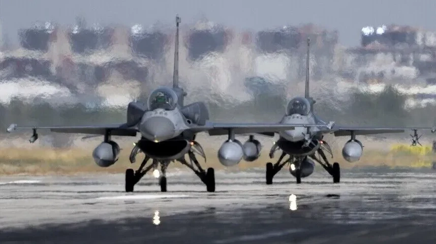 Dva lovačka aviona F-16 nalaze se na pisti, spremni za polijetanje ili slijetanje.