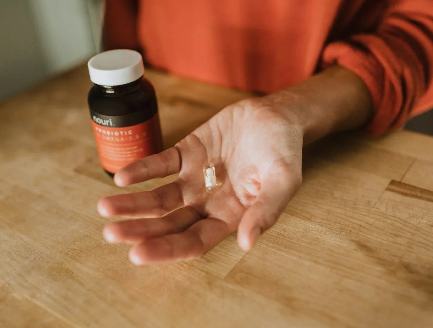 person holding medication pill