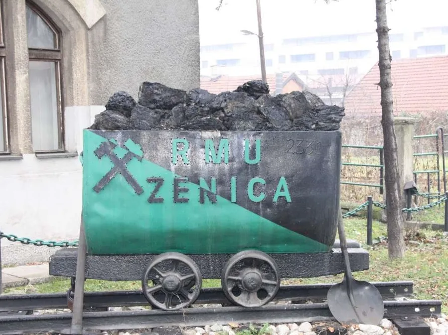 Izložena rudnička kolica sa ispisom "RMU ZENICA" i simbolom rudarskih alata.